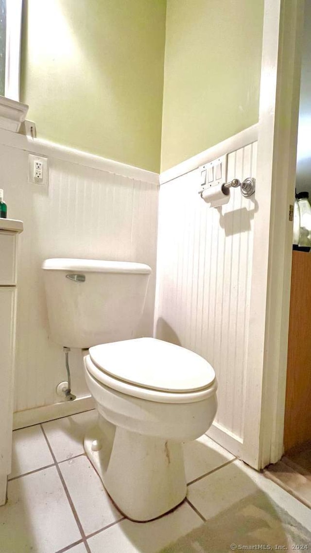 bathroom featuring tile patterned flooring, vanity, and toilet