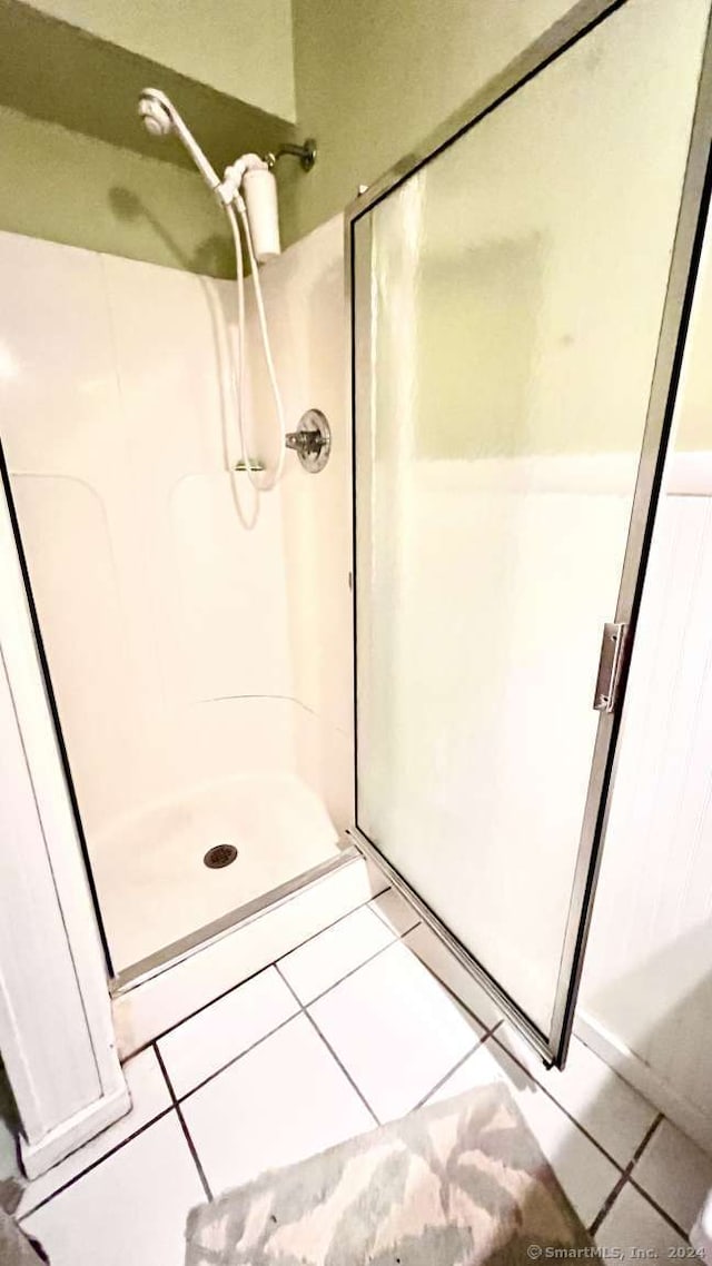 bathroom featuring tile patterned floors and a shower with door