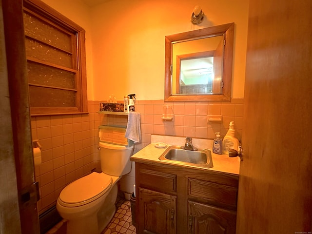 bathroom featuring vanity, tile walls, and toilet