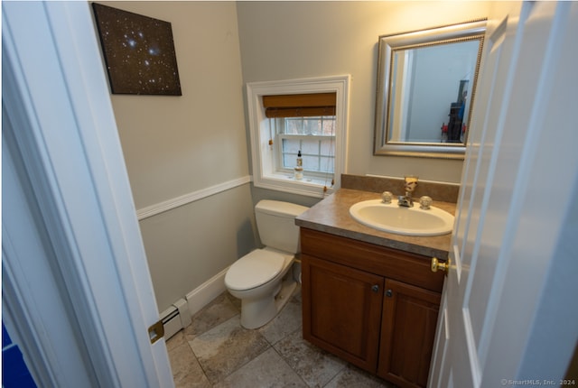 bathroom featuring tile patterned flooring, vanity, toilet, and baseboard heating