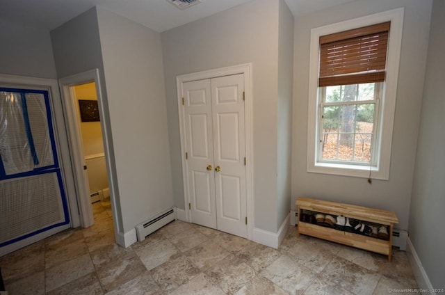 entryway featuring a baseboard heating unit, baseboards, visible vents, and baseboard heating