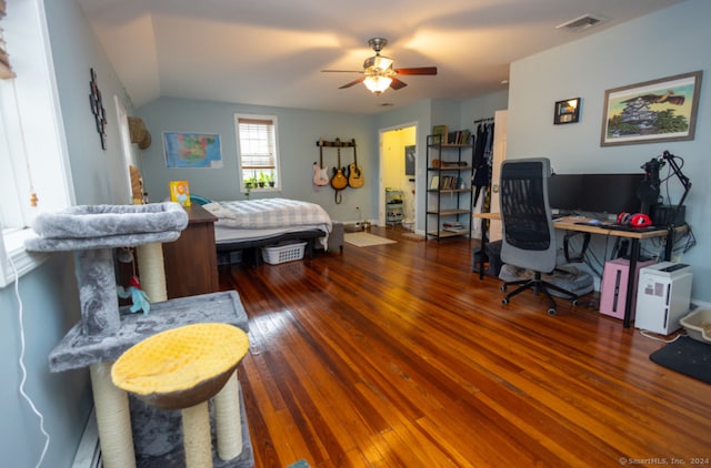 bedroom with hardwood / wood-style flooring, ceiling fan, and lofted ceiling