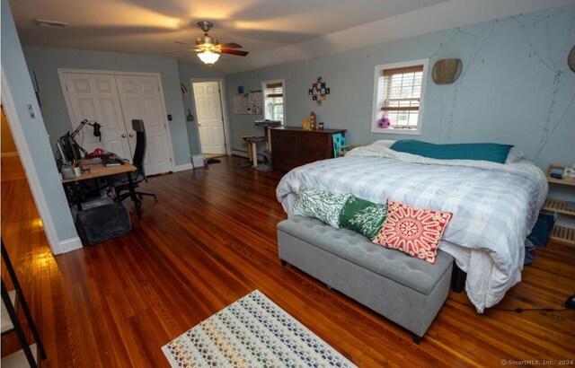 bedroom featuring dark hardwood / wood-style flooring, a closet, and ceiling fan