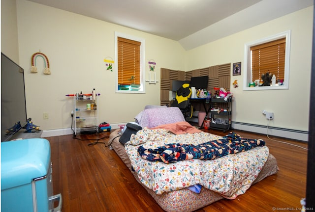 bedroom featuring hardwood / wood-style floors and baseboard heating