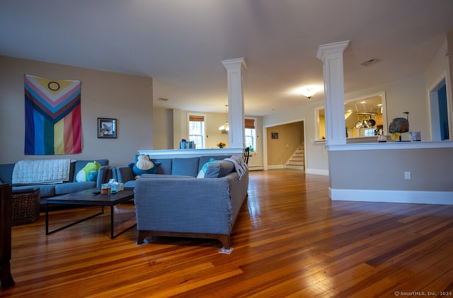 living room with wood-type flooring and a chandelier