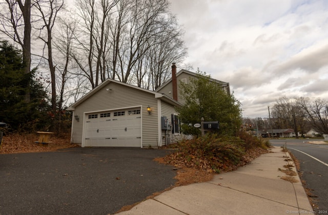 view of side of home featuring a garage