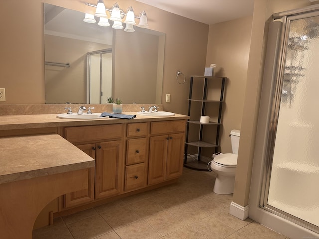 bathroom featuring double vanity, a sink, a shower stall, and tile patterned floors