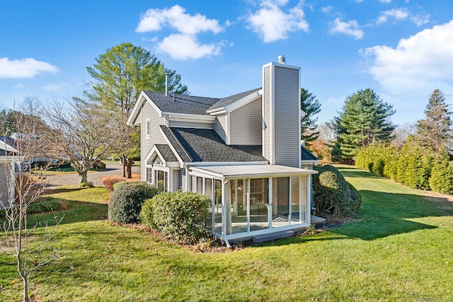 view of home's exterior featuring a lawn and a sunroom