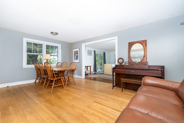 dining space with light wood-style floors and baseboards