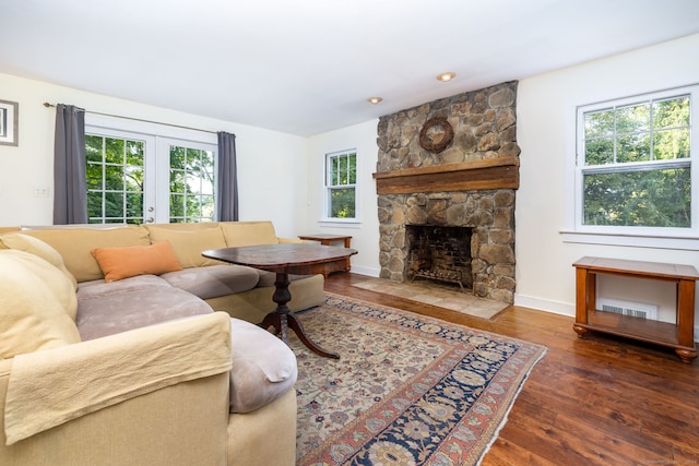 living area featuring plenty of natural light, baseboards, wood finished floors, and french doors