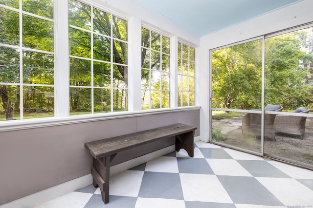 sunroom featuring tile patterned floors and plenty of natural light