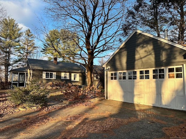 exterior space featuring a chimney and a detached garage