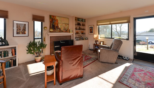 carpeted living room featuring a fireplace