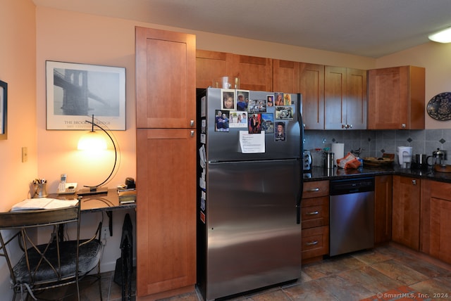 kitchen featuring backsplash, appliances with stainless steel finishes, and dark stone counters