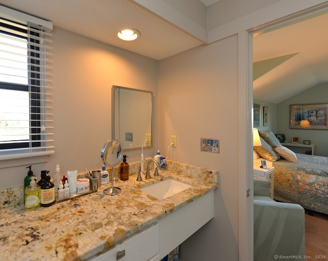 bathroom featuring vanity and vaulted ceiling