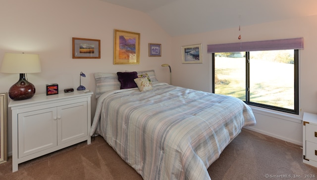 bedroom featuring light carpet and lofted ceiling