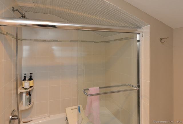 bathroom featuring lofted ceiling and walk in shower