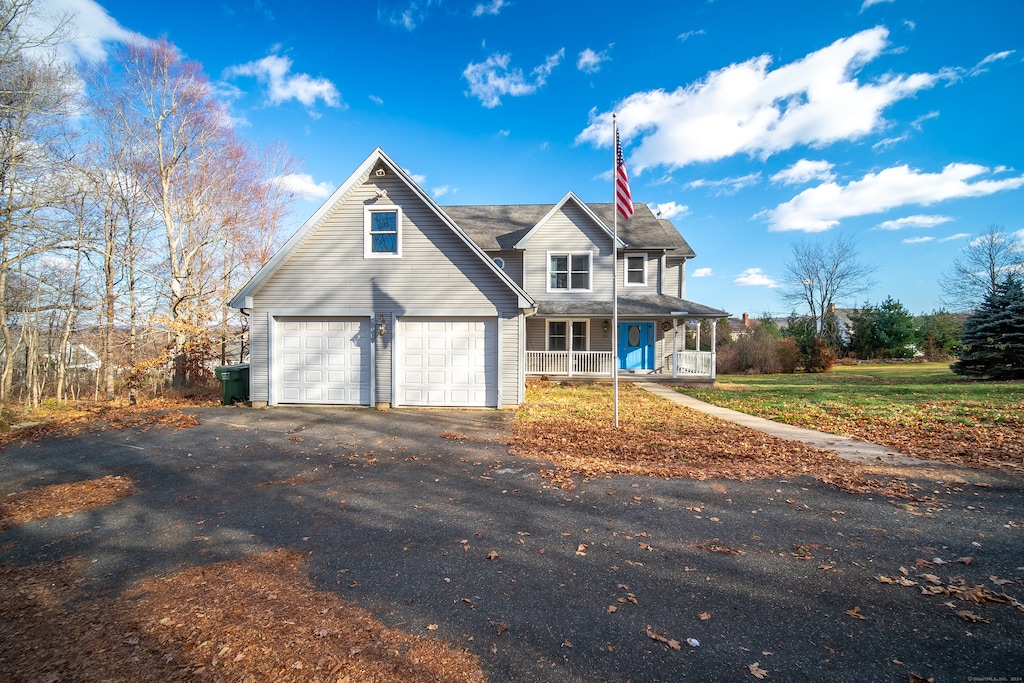 view of front of property with covered porch and a front lawn