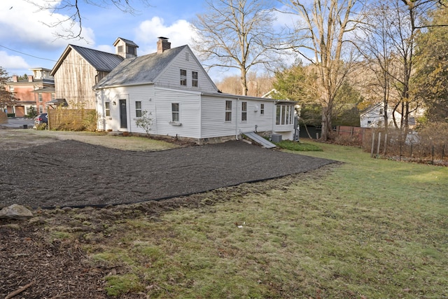 rear view of property with a yard