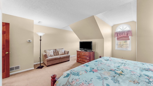 bedroom with a textured ceiling, lofted ceiling, and carpet floors