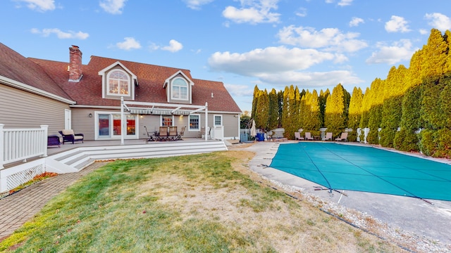 view of swimming pool with a pergola, a lawn, and a deck