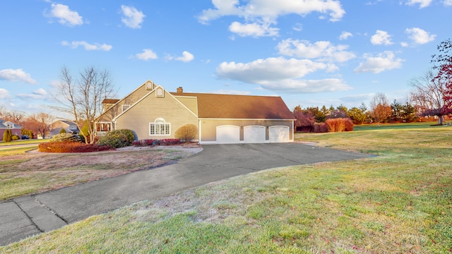 view of front of house featuring a garage and a front lawn