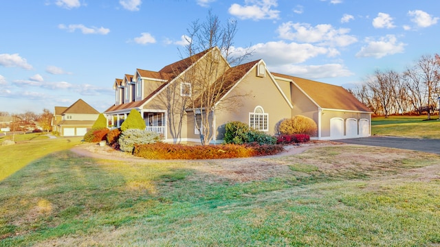 view of front of home with a front yard and a garage