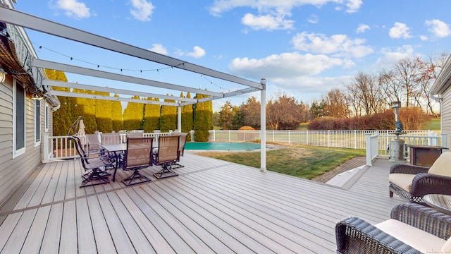 deck featuring a lawn, a fenced in pool, and a pergola