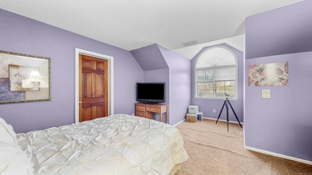 bedroom featuring carpet and vaulted ceiling