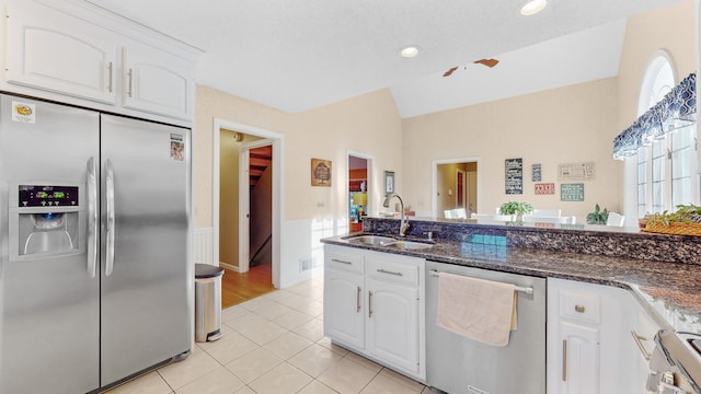 kitchen featuring appliances with stainless steel finishes, a textured ceiling, ceiling fan, sink, and white cabinetry