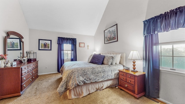 bedroom featuring light colored carpet and lofted ceiling