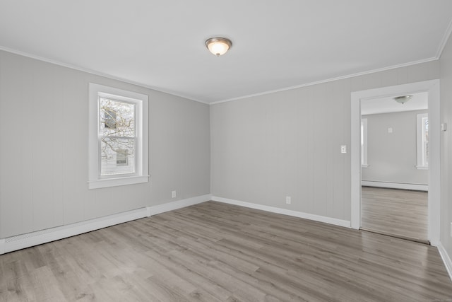 empty room with baseboard heating, light hardwood / wood-style flooring, and ornamental molding