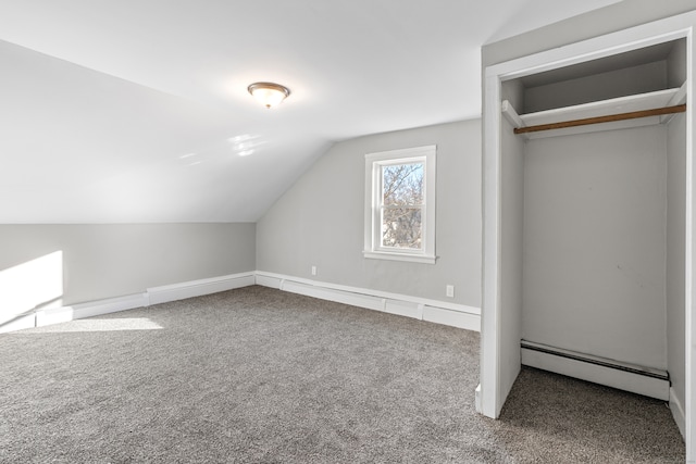 additional living space with carpet, vaulted ceiling, and a baseboard radiator