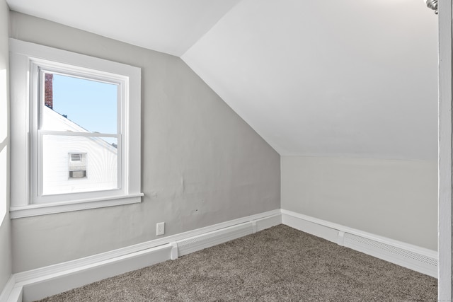 bonus room featuring carpet floors and vaulted ceiling