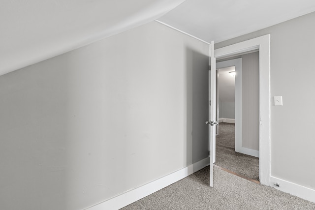 bonus room featuring light colored carpet and vaulted ceiling