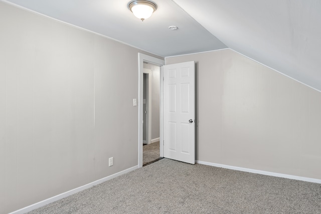 additional living space with carpet flooring and lofted ceiling