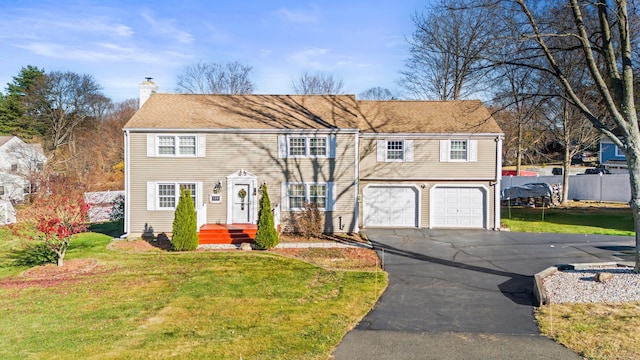 view of front of house with a front yard and a garage