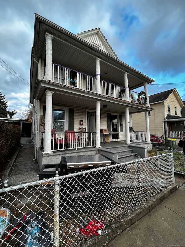 view of front of home with a porch and a balcony