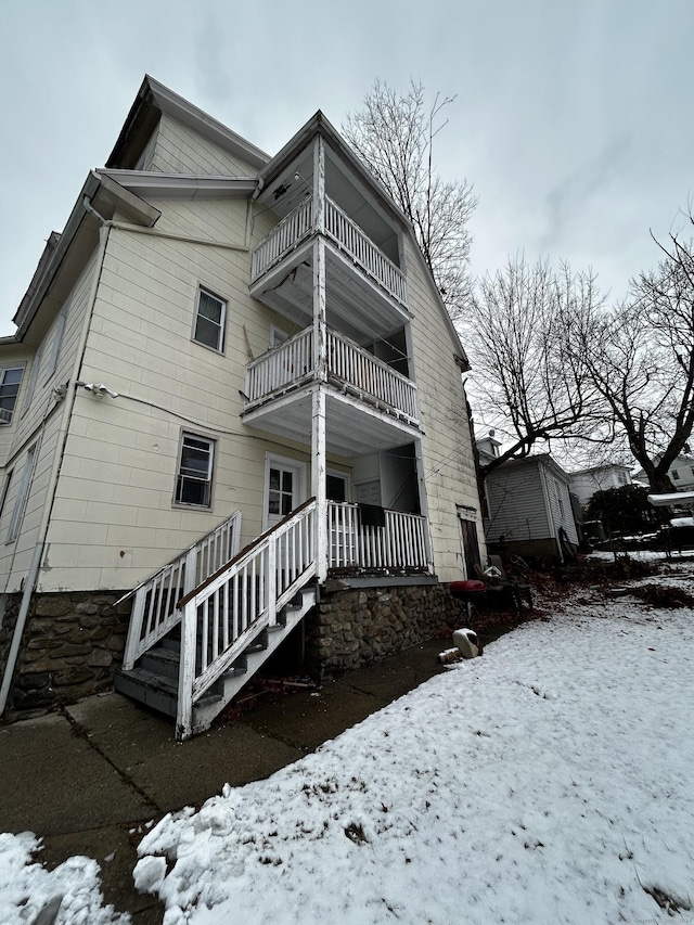 view of snowy exterior with a balcony