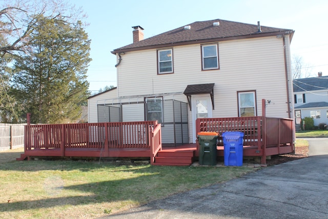 back of house with a yard and a wooden deck