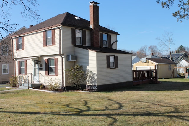 back of house featuring a yard and a wall mounted AC