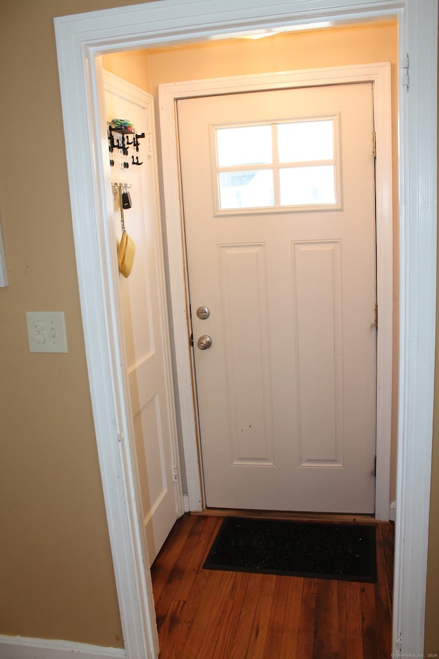 doorway to outside with wood-type flooring