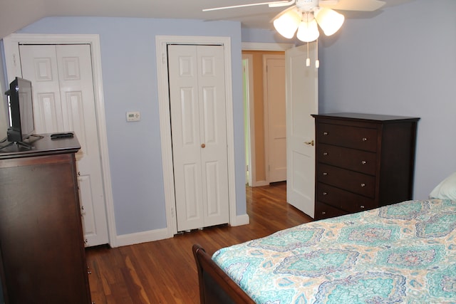 bedroom with multiple closets, ceiling fan, and dark hardwood / wood-style floors