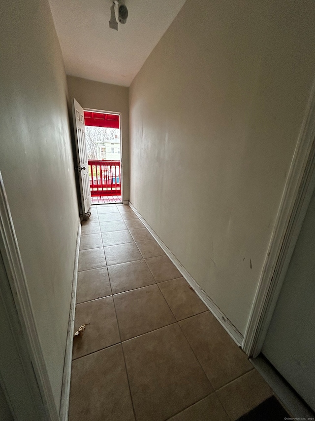 hallway with tile patterned flooring