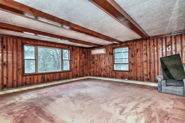 unfurnished living room with a wall unit AC, a textured ceiling, and wooden walls