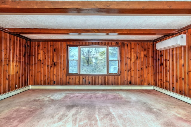 unfurnished room with beam ceiling, a wall mounted AC, wood walls, and carpet