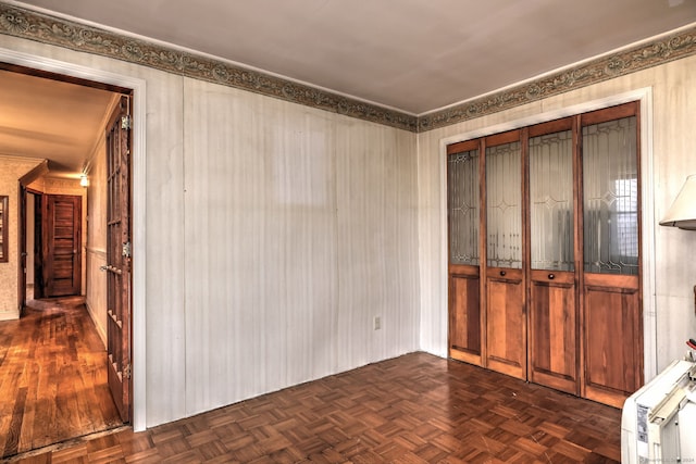 unfurnished bedroom featuring dark parquet floors