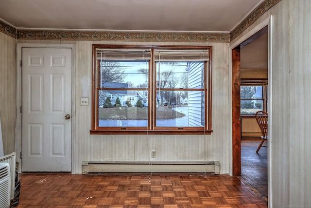 interior space featuring dark parquet flooring and baseboard heating