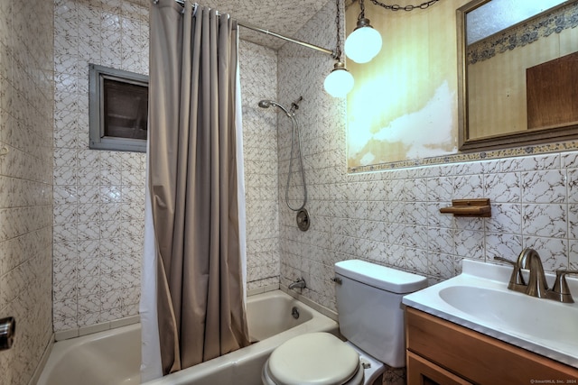 full bathroom with vanity, toilet, tile walls, and shower / tub combo with curtain