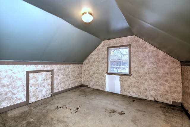 bonus room with carpet flooring and lofted ceiling